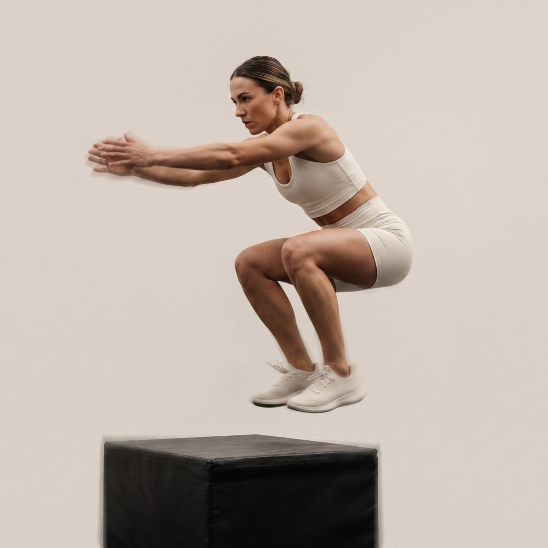 A person mid-swing with a kettlebell in a gym